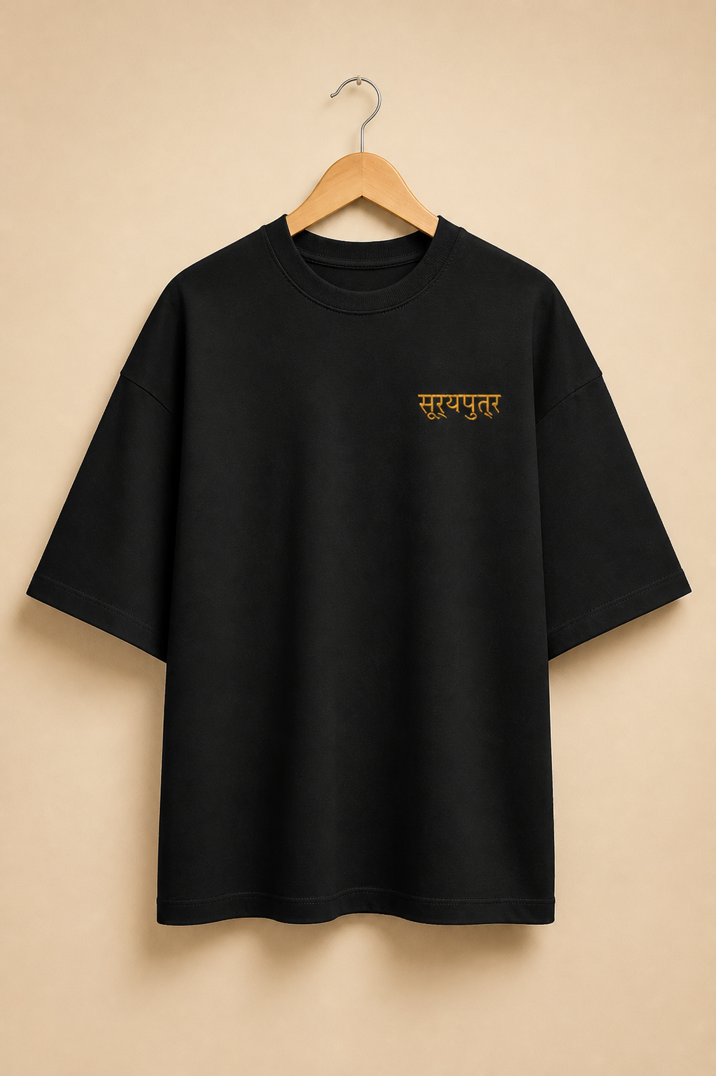 Suryaputra oversized tee in black – front chest wordmark on hanger