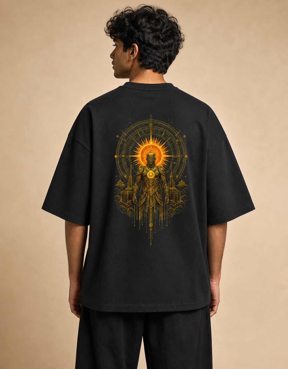 Suryaputra oversized tee in black – golden sun-deity back print worn by model